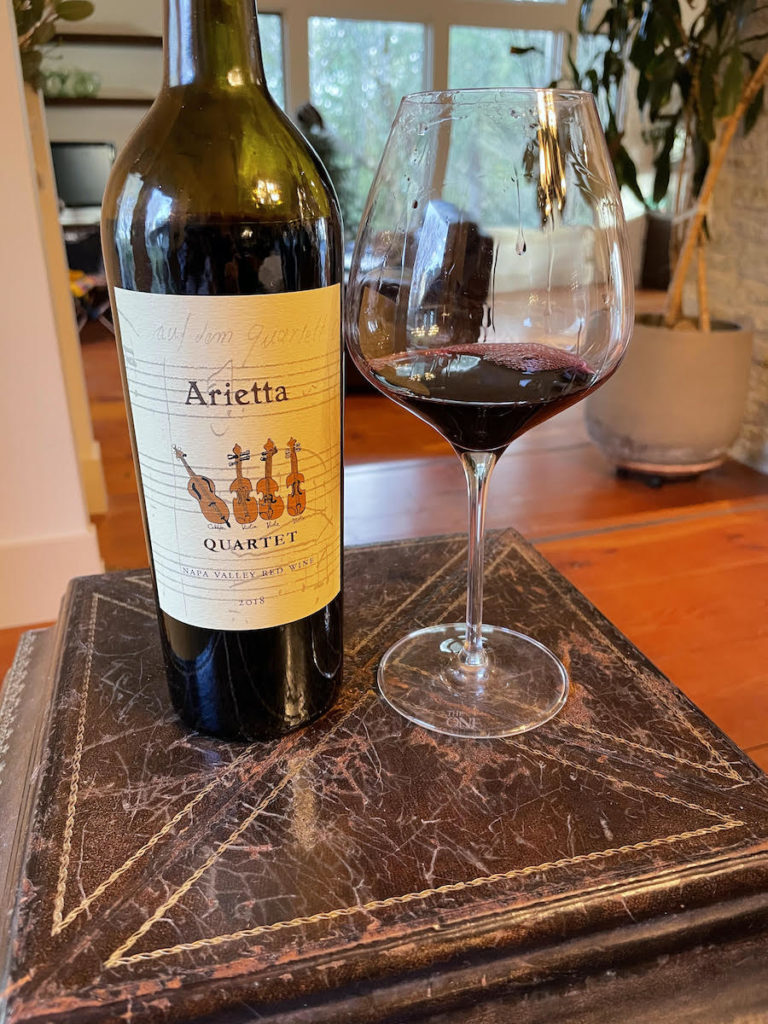 alt="Arietta 2018 Quartet Proprietary Red bottle and glass"