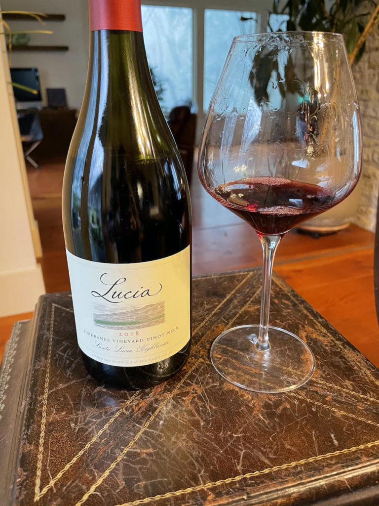 alt="Lucia 2018 Pinot Noir Soberanes Vineyard bottle and glass"