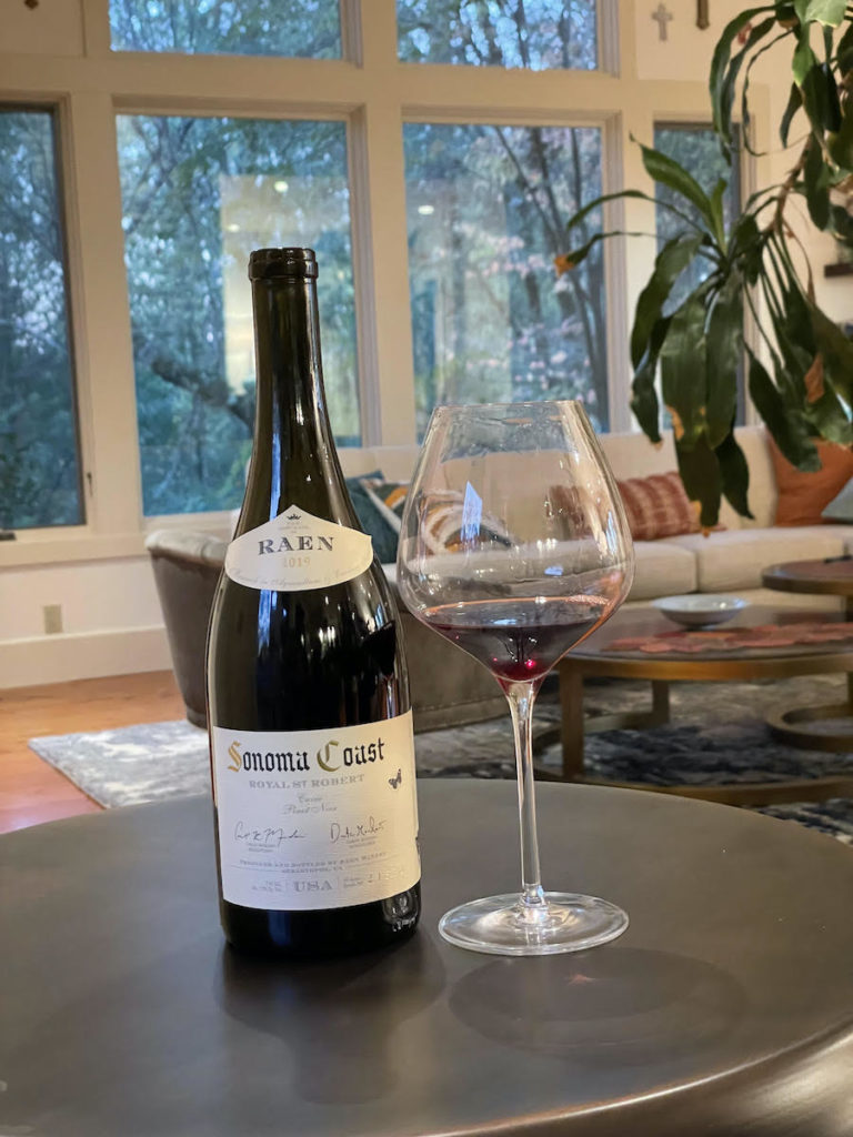 alt="Raen 2019 Royal St. Robert Pinot Noir bottle and glass"