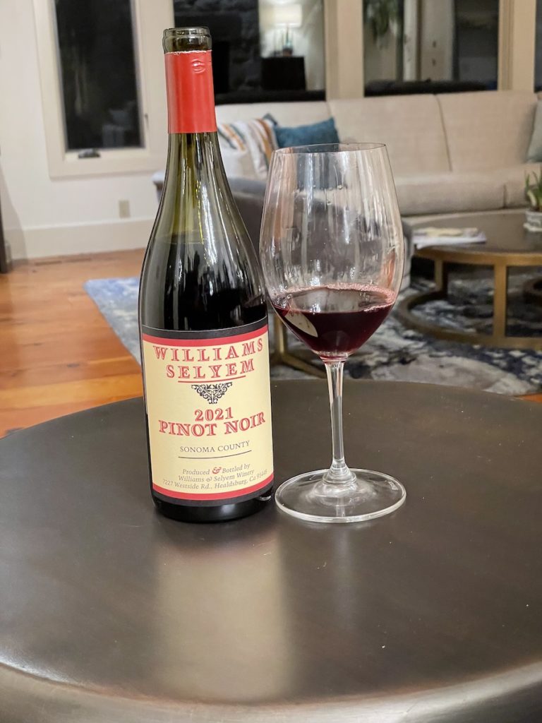 alt="Williams Selyem Sonoma County Pinot Noir bottle and glass"