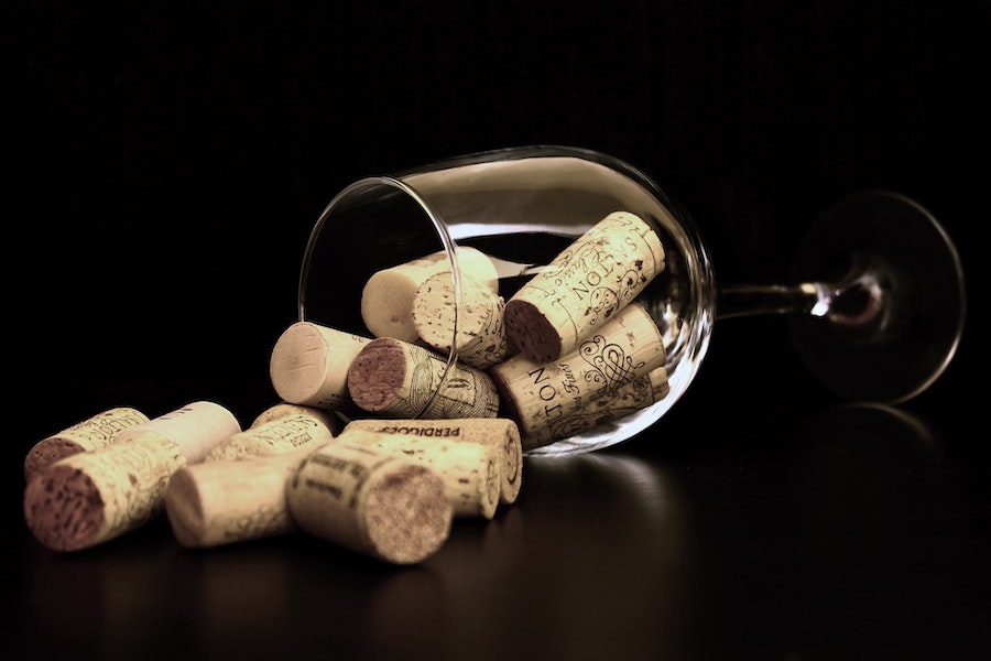 alt="wine corks pouring out of glass"