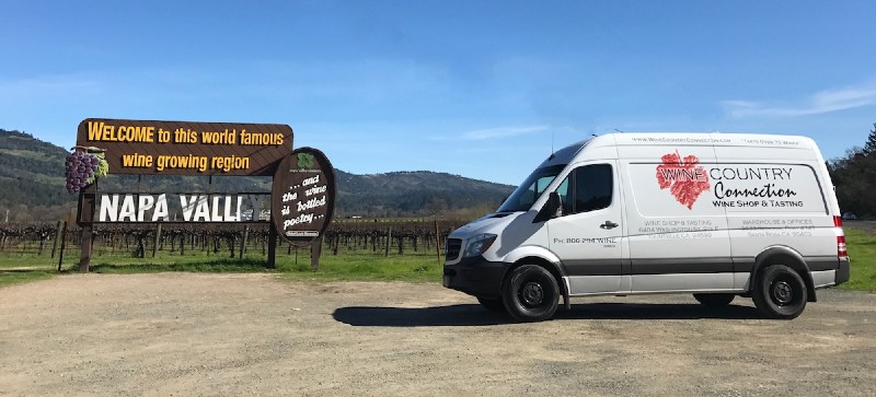 alt="Napa Valley sign with Wine Country Connection van"