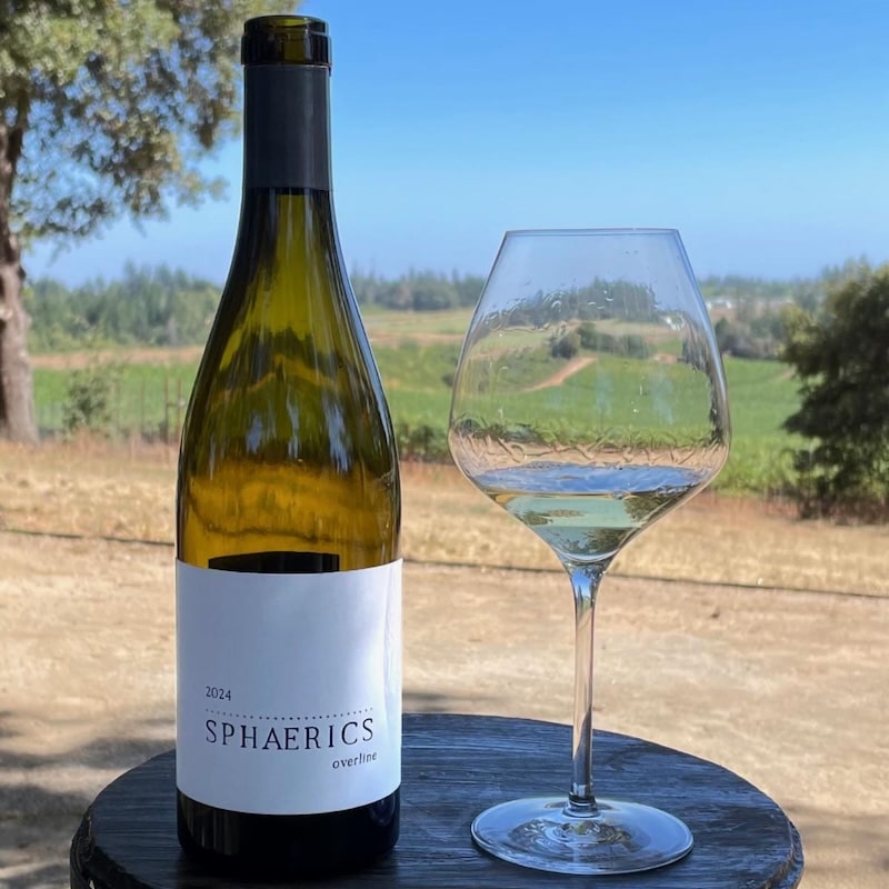 Sphaerics Overline Chardonnay bottle and glass on patio table